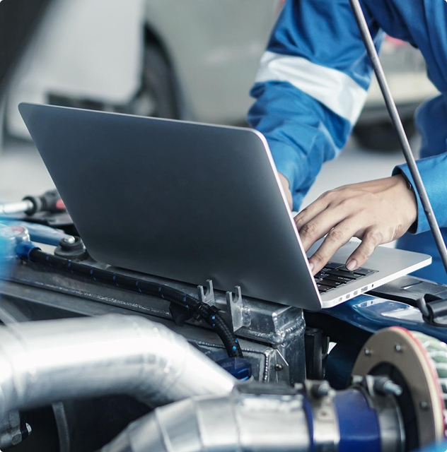 Mechanic using laptop in workshop